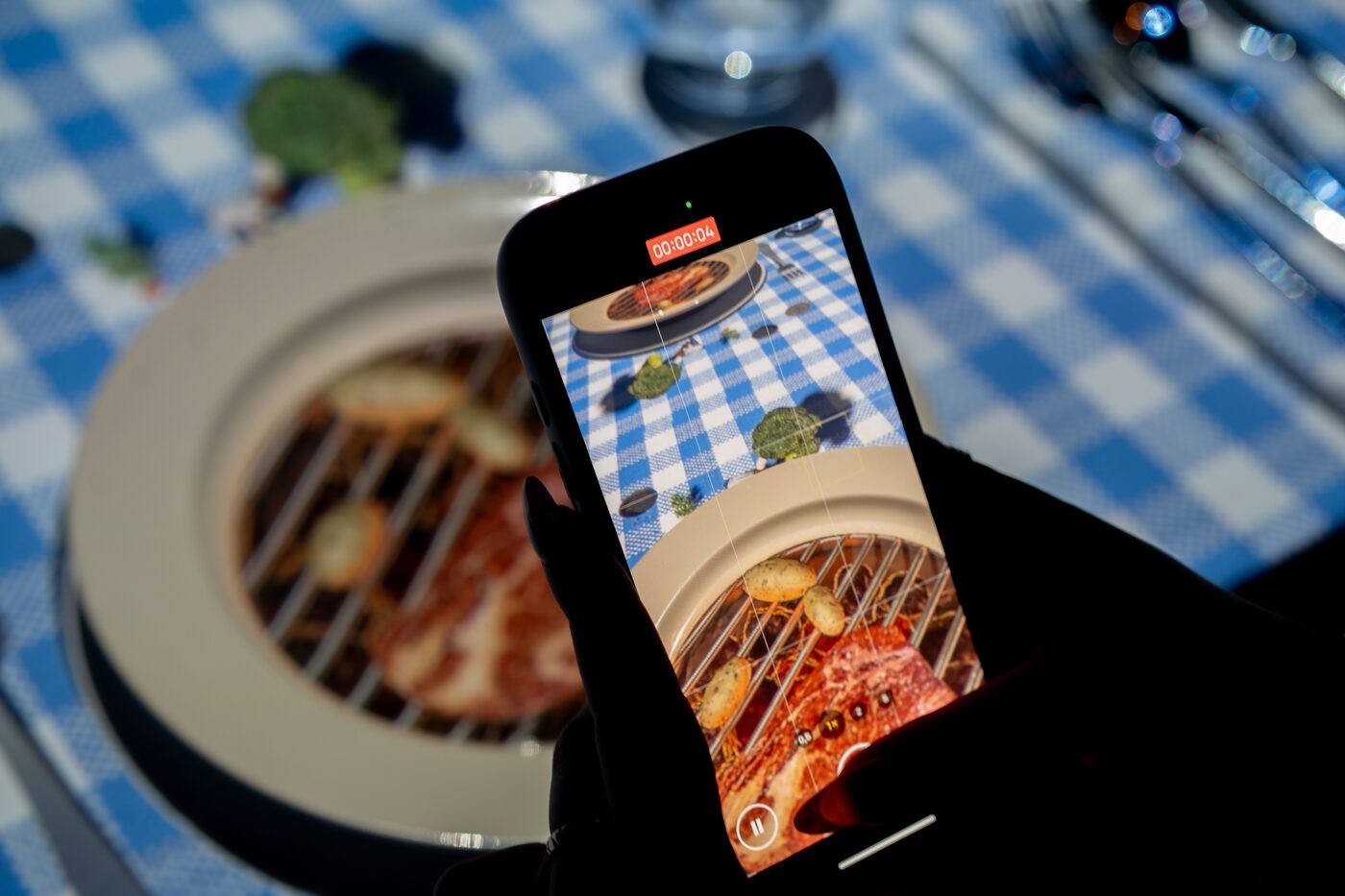 Guest filming the 3D table projection on a phone